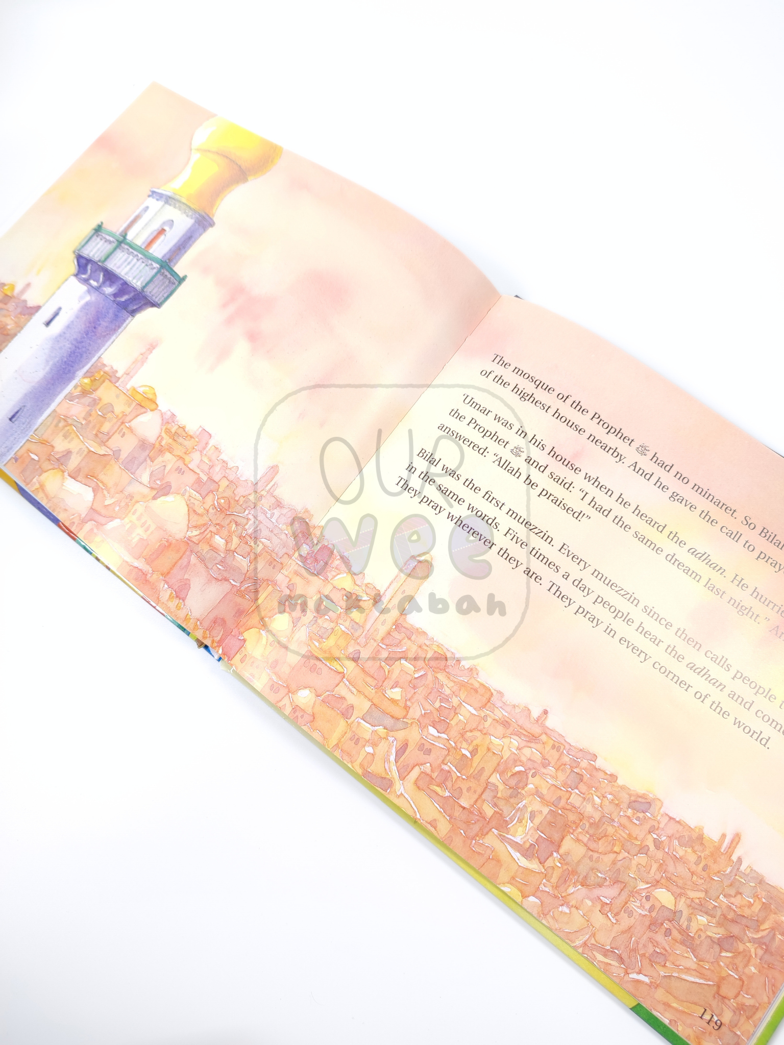 A sample page from Goodnight Stories from the Life of Prophet Muhammad showing a beautiful double page illustration of a minaret and buildings of a town in the background